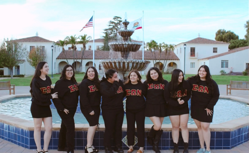 SON members around the CI fountain in letter sweatshirts